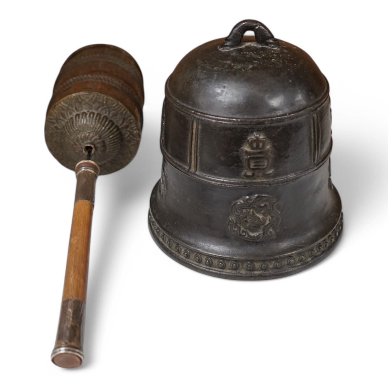 A late 19th/early 20th century Tibetan prayer wheel, with silver mounted bamboo handle, and a Southeast Asian bronze bell, largest 28cm wide. Condition - fair